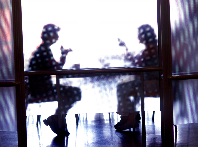 Image of two people having a conversation