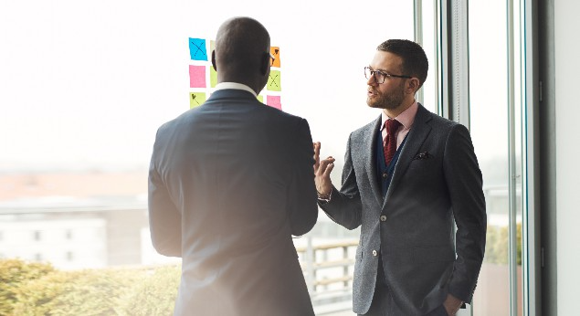 two business executives discussing market mapping and talent pipelining